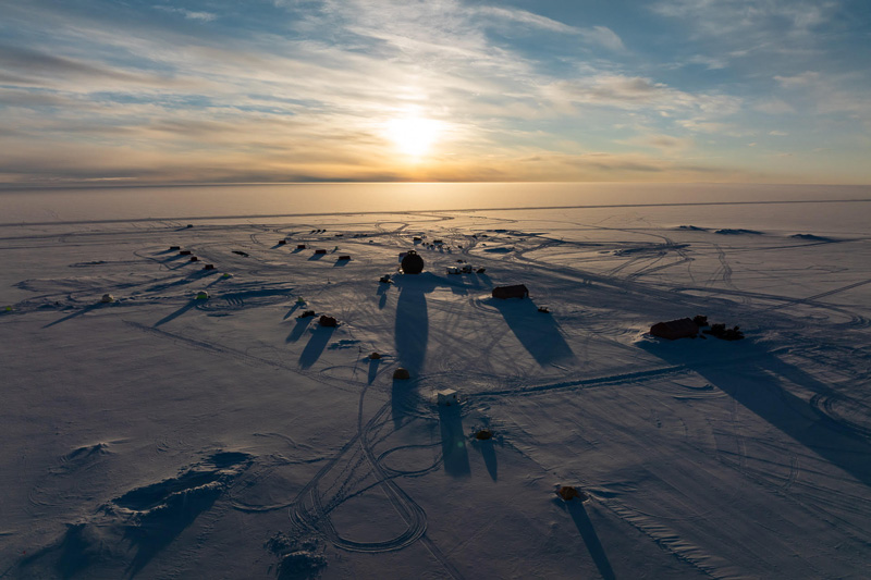 An aerial view of the East Greenland Ice-Core Project (EastGRIP) camp at midnight