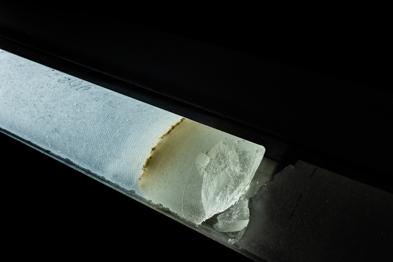 An ice core from a depth of 2215 meters with a layer of volcanic ash